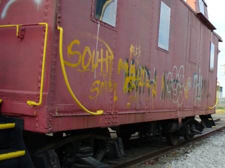 The caboose at the train station covered in graffiti last year