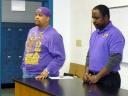 Members of Omega Psi Phi teach a young boys about Rev. Martin Luther King, Jr.