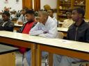 Young boys listen to the men from Omega Psi Phi