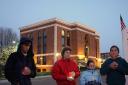 Vigil members stand in front of City Hall which lit the “Eternal” flame to mark the 4000th US death in Iraq