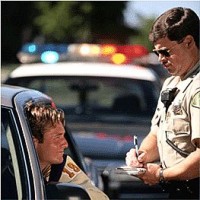 A police officer writes a speeding ticket