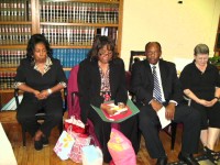 With gifts gathered around her, Managing Atty Pat Mock reflects