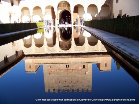 A reflecting pool with the Alhambra in the background in Granada, Spain.