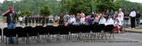 A chair is put into place as the crowd and color guard looks on