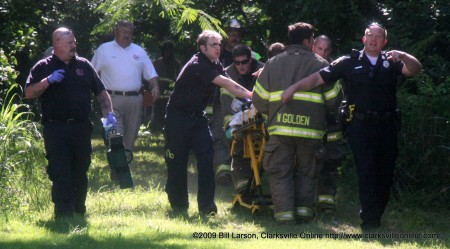 Clarksville, TN - Emergency Responders rush the victim out of the woods