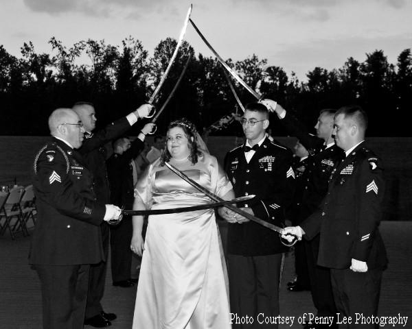 Matt and Ashley Parsons walk through the Military Arch of Sabers at the Sept. 4 wedding.