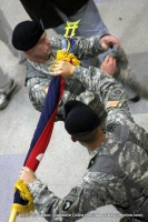 Command Sgt. Maj. Gregory Patton (Left) & Col. Viet Luong (Right), case the brigade colors before heading to Afghanistan