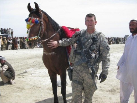 U.S. Army 1st Lt. James Ferguson, a fire support officer with Company A, 3rd Battalion, 187th Infantry Regiment, 3rd Brigade Combat Team, 101st Airborne Division, poses with a horse in Sharana city in Afghanistan’s Paktika province, March 21, during the New Year’s sangay festivities. Sangay is a competition in which men on horseback use spears to attempt to dislodge a spike from the ground. The Soldiers from 3-187 INF joined approximately 600 residents from the city for the celebration. (U.S. Army photo) U.S. Army 1st Lt. James Ferguson, a fire support officer with Company A, 3rd Battalion, 187th Infantry Regiment, 3rd Brigade Combat Team, 101st Airborne Division, poses with a horse in Sharana city in Afghanistan’s Paktika province, March 21, during the New Year’s sangay festivities. Sangay is a competition in which men on horseback use spears to attempt to dislodge a spike from the ground. The Soldiers from 3-187 INF joined approximately 600 residents from the city for the celebration. (U.S. Army photo)