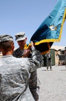 U.S. Army Lt. Col. Paul Sarat, the outgoing Commander of 3rd Special Troops Battalion, hands the battalion colors to U.S. Army Col. Viet Luong. (SSG. Whitney Hughes)