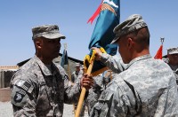 Col. Viet Luong the Brigade Commander of 3rd Special Troops Battalion hands the battalion colors to Lt. Col. Walter Smiley the incoming Commander of Oklahoma City, Ok. during a Change of Command Ceremony held at Forward Operating Base Gardez May 25. (SSG Whitney Hughes)