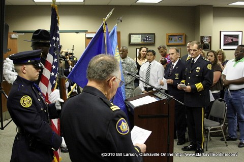 Chaplin Bob Mitchell reads from the program during the Police Department's Memorial Serivce 