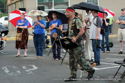 The chair of USAF Maj. Howard V. Andre Jr from Memphis Tennessee is carried up by a member of the Vietnam Veterans Motorcycle Club