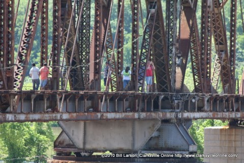 Walking on a railroad bridge above a flooded river isn't a good idea