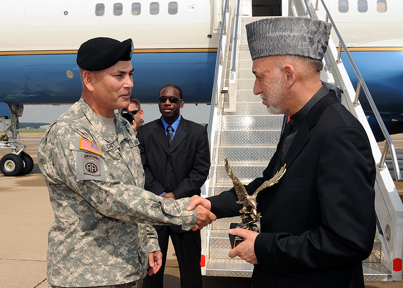 The U.S. Army Major General John Campbell the Commanding General of the 101st Airborne Division (Air Assault) "Screaming Eagles" presents the President of Afghanistan, Hamid Karzai a departing gift at Campbell Army Airfield, Fort Campbell, KY on 14 May 2010. The President of Afghanistan, the Secretaries of Defense for the U.S. and Afghanistan, the Chairman of the Joint Chiefs of Staff and other distinguished visitors were on a short visit to Fort Campbell. U.S. Army Photo by Sam Shore
