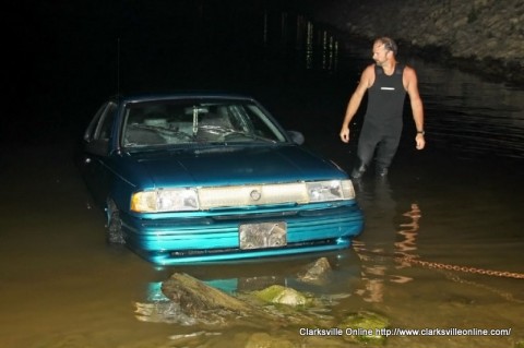 Montgomery County Rescue Squad diver Tim Manners inspects the car as it is pulled from the water