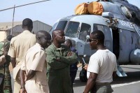 Spc. Ephraim Amou-Berry (right) from the 160th Special Operations Aviation Regiment (Airborne), at Fort Campbell, KY, talks with members of the Senegalese military at an airfield in Thies, Senegal. (Photo courtesy of 160th Special Operations Aviation Regiment Public Affairs)