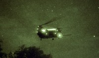 Seen through a night vision lens, a CH-47 Chinook helicopter from the 160th Special Operations Aviation Regiment circles above Muscatatuck Urban Training Center, Ind., during night operations, June 10th. (Photo by Sgt. Brad Staggs, Camp Atterbury Public Affairs)