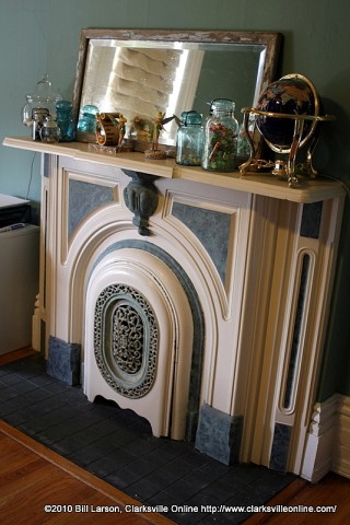 A working fireplace with an iron ornamental cover A working fireplace with an iron ornamental cover