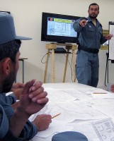 Afghan National Police Captain Safat Ullah Sangee, Panjshir Operations Coordination Center-Provincial, teaches a map and compass reading techniques class July 13th. This class was the second day of Sangee's three-day course at the Rokha Police Headquarters.(Photo by U.S. Air Force 2nd Lt. Jason Smith, PRT Panjshir Public Affairs)