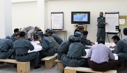 Afghan National Police Captain Safat Ullah Sangee, Panjshir Operations Coordination Center-Provincial, teaches a map and compass reading techniques class July 13th.Some of the things Sangee taught included how to use a protractor with a map, give grid coordinates, find grid coordinates, identify terrain features and measure distance between points. (Photo by U.S. Air Force 2nd Lt. Jason Smith, PRT Panjshir Public Affairs)