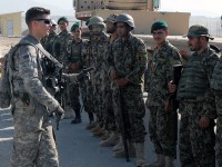 U.S. Army Cpl. Douglas Roberts, a platoon NCO with Headquarters, Headquarters Company, 82nd Main Support Battalion and Richmond, VA native, explains the process of recovering an air drop to Afghan National Army soldiers from the 201st Flood Corps before conducting a resupply air drop mission at Forward Operating Base Gamberi, July 10th. The air drop consisted of wood to build new buildings, Hesco barriers for base security, water and Halal meals, ANA's version of Meals Ready to Eat.