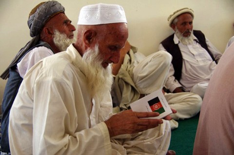 An elder reads a copy of the Afghan constitution as he joins more than 100 elders affected by the recent operations in eastern Kunar province who gathered in the Shura hall of the Marawara district center July 10th. The Kunar Provincial Reconstruction Team tutored the elders about Afghan law and government. (Photo by Abraham Sutherland, Kunar Provincial Reconstruction Team) An elder reads a copy of the Afghan constitution as he joins more than 100 elders affected by the recent operations in eastern Kunar province who gathered in the Shura hall of the Marawara district center July 10th. The Kunar Provincial Reconstruction Team tutored the elders about Afghan law and government. (Photo by Abraham Sutherland, Kunar Provincial Reconstruction Team)