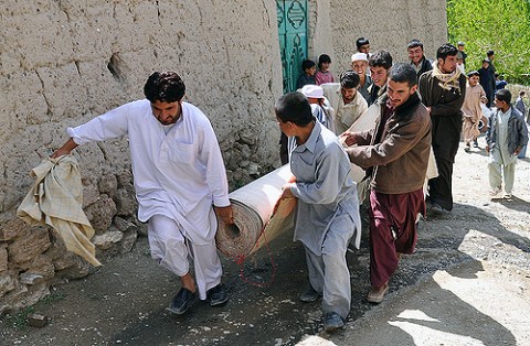 Afghan men carry a roll of carpet to a Surkhab Valley mosque as part of a refurbishment project overseen and assisted by Task Force Brawler. (Photo by U.S. Army Sgt. Scott Tant 4th Battalion, 3rd Aviation Regiment, Task Force Brawler)