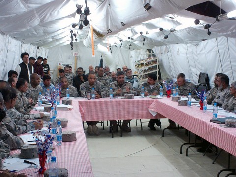 Lt. Col. Walter J. Smiley Jr., battalion commander, 3rd Special Troops Battalion, 101st Airborne Division (center left) listens as Maj. Gen. Mullah Khil, commanding general, ABP Zone 2 (center right) speaks at a recent commander's conference at Camp Ghardez.