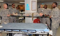 A team of litter-bearer volunteers learn how to properly move a patient from a litter to a hospital bed in the emergency room of the Salerno Hospital.  The training took place during a recent litter-bearer class to help ensure injured patients get the assistance they need as soon as possible. (Photo by U.S. Sgt. Brent C. Powell, 3rd Brigade, 101st Airborne Division)