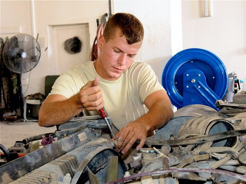 U.S. Army Sgt. Phillip T. Brown, from Pensacola, FL, a wheeled vehicle mechanic and shop foreman for the maintenance platoon, Company G, 626th Brigade Support Battalion, 3rd Brigade, 101st Airborne Division, loosens the screw of a hose clamp on the engine of a humvee in the unit’s maintenance shop.  (Photo by U.S. Army Sgt. Brent C. Powell, 3rd Brigade, 101st Airborne Division)