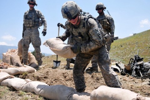 U.S. Army Pfc. David W. Wilson, of Salisbury, NC, a grenadier with 1st Squad, 2nd Platoon, 2nd Battalion, 327th Infantry Regiment, Task Force No Slack, stacks sandbags in an effort to improve a fighting position at Combat Outpost Thomas above the Marawarah District here July 7th.(Photo by U.S. Army Spc. Albert L. Kelley, 300th Mobile Public Affairs Detachment)