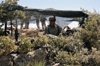 U.S. Army Pfc. Johnathan R. Villarreal, of San Benito, Texas, an automatic rifleman with 1st squad, 2nd Platoon, Company D, 2nd Battalion, 327th Infantry Regiment, Task Force No Slack, scans the area below from the security of a fighting position that he and his squad built at Combat Outpost Thomas. (Photo by U.S. Army Spc. Albert L. Kelley, 300th Mobile Public Affairs Detachment)