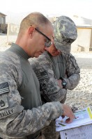 U.S. Army Sgt. 1st Class Daniel E. Talley, the platoon sergeant for 1st Plt., 287th Engineer Co., and U.S. Army Staff Sgt.  Casey D. Mitchell, the squad leader for 2nd Squad, 1st Plt., 287th Engineer Co., discuss plans before a route clearance mission July 18th. (Photo by U.S. Army Sgt. Spencer Case, 304th Public Affairs Detachment)