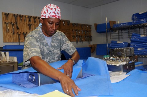 Staff Sgt. Judi Reeves, a surgical technician from the 344th Combat Support Hospital here, and native of Middletown, NY, carefully folds cloth over a vascular surgical tray of medical instruments before placing it into a sterilizing machine at the Salerno Hospital.  (Photo by Sgt. Brent C. Powell, 3rd Brigade, 101st Airborne Division public affairs)