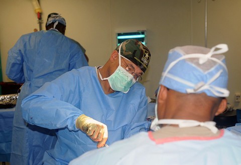 Lt. Col. Paul Phillips, an orthopedic surgeon assigned to the 344th Combat Support Hospital here, performs surgery on a 14-year-old local Afghan boy who sustained a gunshot wound to his arm.  Phillips, a native of Arlington, Texas, is one of four surgeons at the Salerno Hospital. (Photo by Sgt. Brent C. Powell, 3rd Brigade, 101st Airborne Division public affairs)