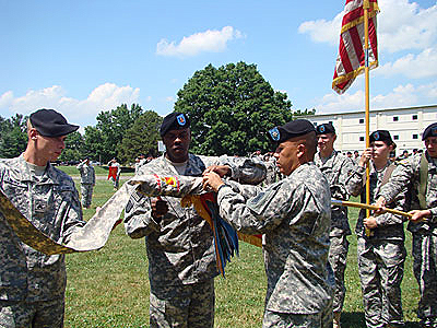 2-44th Air Defense Artillery Battalion Commander LTC Thomas Nguyen cases the colors as they prepare to deploy to Afghanistan in support of Operation Enduring Freedom. The battalion had been scheduled to de-activate for nearly five years before being re-activated earlier this year. - Photo by Capt. Shannon Clark | 2-44th Ada