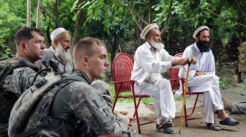 From left, U.S. Army Sgt. 1st Class Kenneth R. Shriver of Clarksville, TN, a platoon sergeant, and 1st Lt. Hugh A. Lewis of Layton, Utah, a platoon leader, both with 1st Battalion, 327th Infantry Regiment, Task Force Bulldog, join with elders of the village of Shamun in eastern Afghanistan’s Kunar province July 14th to listen to discussions of various local programs. (Photo by U.S. Army Staff Sgt. Gary A. Witte, 300th Mobile Public Affairs Detachment)