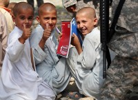 Afghan children give the thumbs up after receiving new school supplies from Staff Sgt. Nicole Olcott, of Daytona Beach, FL,  in the Beshood district of eastern Afghanistan’s Nangarhar province Aug. 14th. (Photo by U.S. Army Spc. Albert L. Kelley, 300th Mobile Public Affairs Detachment)