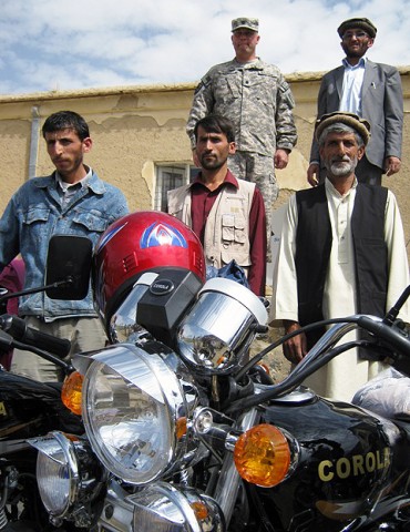 U.S. Army Lt. Col. Jeffrey Casada (back, left), Kentucky National Guard Agribusiness Development Team leader with Panjshir Provincial Reconstruction Team, Abdul Monan (back, right), Panjshir National Environmental Protection Agency director, and three NEPA employees pose in front of brand new motorcycles.(Photo by U.S. Air Force 2nd Lt. Jason Smith, Panjshir PRT Public Affairs)