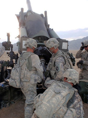 U.S. Army Spc. Nathaniel Hogan of Ashland, KY, 3rd Platoon, A Battery, 2nd Battalion, 320th Field Artillery Regiment, TaskForce Balls, U.S. Army Pfc. Jordan Gaddy of Wichita, KS, and U.S. Army Pfc. Matthew Wiebers of Thornton, CO, load 95 pound projectile into the howitzer.  (U.S. Armycourtesy photo)