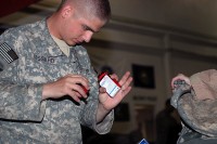 U.S. Army Pfc. Peter Lessard, 342nd Military Police Company customs agent and Concord, NH, native, inspects the contents of a redeploying Airman’s baggage at the Bagram Airfield’s customs terminal August 2nd. Every bag is thoroughly inspected for unauthorized items before it is allowed to leave Afghanistan. (Photo by U.S. Army Spc. Jay Venturini, 304th Public Affairs Detachment)