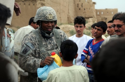 U.S. Army Capt. Terrance McIntosh, distributes much needed supplies to the village of Bashikal in Parwan province during a humanitarian aid mission Aug 25th. The village was recently affected by damaging floods and with the locals observing the holy month of Ramadan, the aid, which included bags of rice and cooking oil, provided a huge boost in morale for the villagers. (Photo by U.S. Army Pfc. Roy Mercon, Task Force Wolverine Public Affairs, 86th Infantry Brigade Combat Team [Mountain])