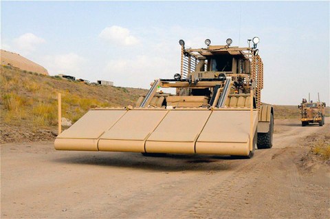 A Soldier driving a Husky vehicle with new Ground Penetrating Radar panels installed, searches for buried improvised explosive devices at a training lane on Forward Operating Base Sharana here Aug. 5th. A Buffalo vehicle stands ready behind the Husky to dig up any suspected IEDs it locates. The new GPR system gives Husky operators a three-dimensional picture of IED threats buried underground. (Photo by U.S. Army Sgt. Brent C. Powell, 3rd Brigade, 101st Airborne Division)