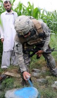 U.S. Army 1st Lt. James D. Horne of Fayetteville, NC, a platoon leader with Company A, 2nd Battalion, 327th Infantry Regiment, Task Force No Slack, marks the boundary of crops outside Combat Outpost Monti in eastern Afghanistan’s Kunar Province Aug. 17th. (Photo by U.S. Army Staff Sgt. Gary A. Witte, 300th Mobile Public Affairs Detachment)