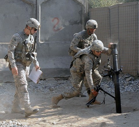 At left, U.S. Army Cpl. Billy Rose of Saginaw, MI, Task Force Bulldog, supervises as Soldiers adjust the still-smoking mortar during a fire mission to protect Combat Outpost Michigan here as it comes under enemy attack July 11th. (Photo by U.S. Army Staff Sgt. Gary A. Witte, 300th Mobile Public Affairs Detachment) At left, U.S. Army Cpl. Billy Rose of Saginaw, MI, Task Force Bulldog, supervises as Soldiers adjust the still-smoking mortar during a fire mission to protect Combat Outpost Michigan here as it comes under enemy attack July 11th. (Photo by U.S. Army Staff Sgt. Gary A. Witte, 300th Mobile Public Affairs Detachment)
