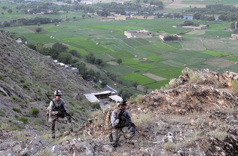 From left, U.S. Army Staff Sgt. Jimmy L. Schumacher of Savannah, TN, and U.S. Army Pfc. David B. James of Brooklyn, NY, with 1st Battalion, 327th Infantry Regiment, Task Force Bulldog, climb to Observation Post Rocky here July 19th. (Photo by U.S. Army Staff Sgt. Gary A. Witte, 300th Mobile Public Affairs Detachment)