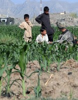 A U.S. Army Soldier with 4th Platoon, Company D, 1st Battalion, 327th Infantry Regiment, Task Force Bulldog, talks to youths near the village of Sanigam. (Photo by U.S. Army Staff Sgt. Gary A. Witte, 300th Mobile Public Affairs Detachment)