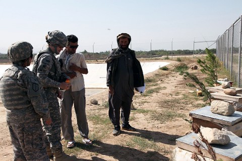 U.S. Army Capt. Bobbie Mayes, along with Mohammad Farid, the horticulture farm manager and project coordinator at Al-Bironi University here, inspect and discuss the growth of five beehives at the university farm August 23rd.(Photo by U.S. Army Spc. Kristina L. Gupton, Task Force Wolverine Public Affairs, 982nd Combat Camera) 