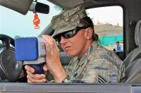 U.S. Air Force Staff Sgt. Shannon N. Ratliff, a security forces patrolman and native of Tacoma, WA, assigned to the 655th Air Expeditionary Squadron, uses a radar gun to check speeds of passing vehicles during recent vehicle safety enforcement checkpoint operations on Forward Operating Base Salerno. (Photo by U.S. Army Sgt. Brent C. Powell, 3rd Brigade, 101st Airborne Division)