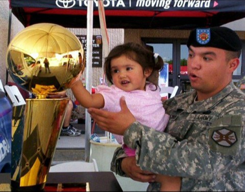 U.S. Army Staff Sgt. Gabriel Villalobos, a military intelligence analyst with Intelligence and Sustainment Co., Headquarters and Headquarters Battalion, 101st Airborne Division, holds his then 4-year-old daughter, Briana, while they check out an NBA trophy at Fort Bliss, Texas, in the summer of 2008. Villalobos is a U.S. citizen who grew up in a Mexican border town. He joined the U.S. Army to give back to the country that has given him so much. (Photo courtesy of U.S. Army)